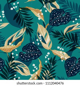 Beautiful tropical leaves. Seamless graphic design with palms leaves and flowers. Fashion,fabric and all prints on stylish green background