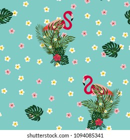 Beautiful tropical seamless pattern with flamingos and flowers. Summer background with flamingos and tropical plants. Birds of the jungle.