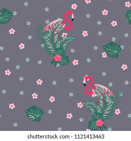 Beautiful tropical seamless pattern with flamingos and flowers. Summer background with flamingos and tropical plants. Birds of the jungle.