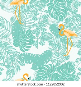 Beautiful tropical seamless pattern with flamingos and flowers. Summer background with flamingos and tropical plants. Birds of the jungle.