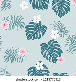 Beautiful tropical seamless pattern with flowers and leaves. Flowers of the jungle. Summer background with tropical leaves and flowers for fabric, wallpaper and cover.