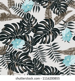 Beautiful tropical seamless pattern with flowers and leaves. Flowers of the jungle. Summer background with tropical leaves and flowers for fabric, wallpaper and cover.
