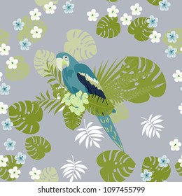 Beautiful tropical seamless pattern with parrot and leaves. Fashionable background with a parrot and flowers. Jungle. Tropical birds.