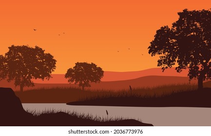Beautiful view of the mountains in the afternoon from the river bank with the silhouette of large trees around it. Vector illustration of a city