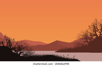 The beautiful view of the mountains at dusk from the riverbank with the silhouette of dry trees around it. Vector illustration of a city