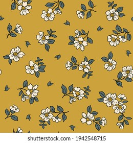 Beautiful vintage floral pattern in small realistic flowers. Small white  flowers. Old gold background. Liberty style print. Floral seamless background. The elegant the template for fashion prints.