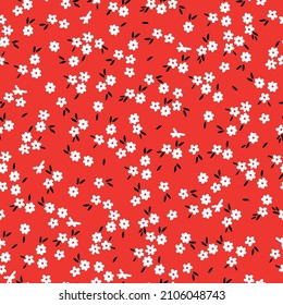 Beautiful vintage pattern. Small white flowers and black leaves. Red background. Floral seamless background. An elegant template for fashionable prints.