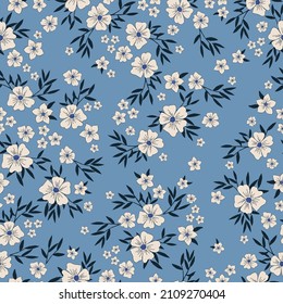 Beautiful vintage pattern. White flowers, dark blue leaves. Light blue background. Floral seamless background. An elegant template for fashionable prints.