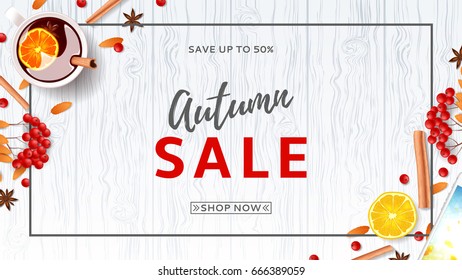 Beautiful web banner for autumn sale. Top view on composition with cup of mulled wine, rowan, cinnamon sticks on wooden texture. Vector illustration.