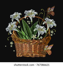 Beautiful white lillies classical embroidery in a wicker basket on black background. Template for clothes, textiles, t-shirt design