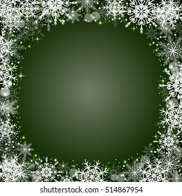 Beautiful winter frame made of snowflakes on green background.