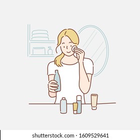 beautiful woman applying cosmetic cream. Hand drawn style vector design illustrations.