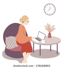 Beautiful woman comfortably working from home, sitting on couch with laptop and cup on the table.