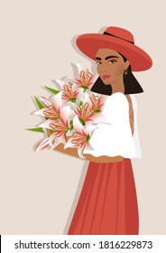 Beautiful Woman in a hat with lily flowers in her hands