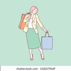 Beautiful woman with many shopping bags on green background. Hand drawn style vector design illustrations.