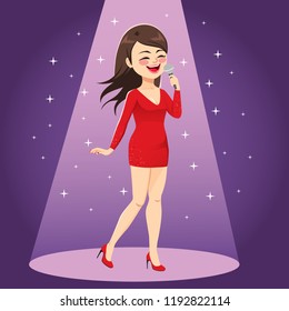 Beautiful woman in red trendy fashion dress singing on stage under spotlight