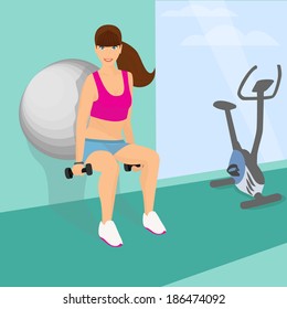 Beautiful woman squats using fitness ball with dumbbells in her hands (lower position)