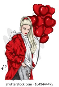 A beautiful woman in a stylish coat. Fashionable clothes and accessories, fashion and style. Heart shaped balloons. Valentine's Day.