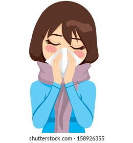 Beautiful woman wearing a warm scarf suffering influenza and runny nose blowing her nose with a handkerchief