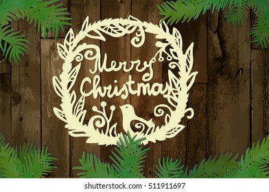 Beautiful wreath with bird and words 'Merry Christmas' on wood texture. Laser cutting