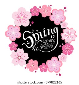 Beautiful wreath with sakura flowers, black circle and white hand drawn lettering "Spring is coming".