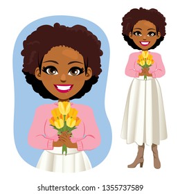 Beautiful young African American woman holding yellow tulips bouquet