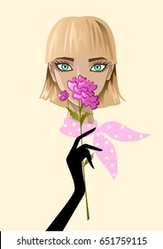Beautiful young blue-eyed girl sniffing flower