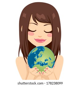 Beautiful young brunette woman holding earth globe showing European continent with her hands