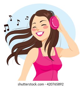 Beautiful young brunette woman listening music with headphones