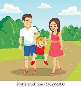 Beautiful young family walking together outdoors on park