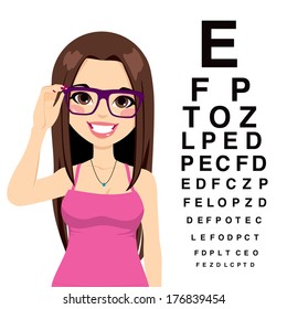 Beautiful young girl with glasses reading sight test characters at ophthalmologist