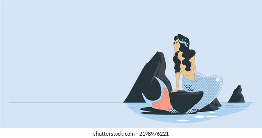 Beautiful young mermaid sitting