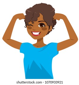 Beautiful young strong powerful African American girl winking eye and showing her muscles with blue shirt