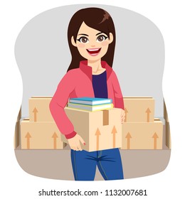 Beautiful young student woman preparing cardboard boxes moving to college dorm