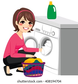 Beautiful young woman doing laundry putting dirty clothes on washing machine from basket