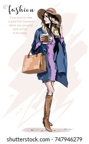 Beautiful young woman in hat. Stylish woman in fashion clothes. Fashion lady. Autumn outfit. Hand drawn girl holding coffee cup. Sketch.