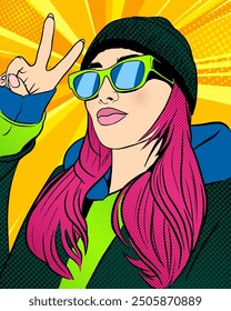 Beautiful young woman in hoodie, hat and sunglasses show peace or victory sign with her hand, pop art portrait, vector illustration