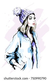 Beautiful young woman in knitted Hat with Fur Pom-Pom. Hand drawn stylish woman portrait. Fashion lady. Winter outfit. Sketch.