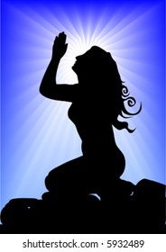 beautiful young woman praying on rock