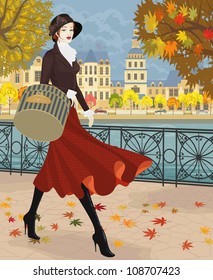 Beautiful young woman walking along embankment in autumn city