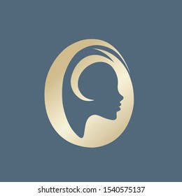 Beauty salon logo.Golden metallic decorative letter O.Beautiful woman profile view portrait.Lettering icon.Alphabet initial sign for hair, spa and aesthetics business.Modern, elegant, luxury style.