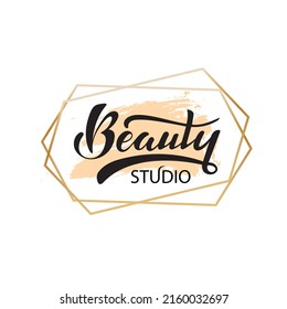 Beauty studio. Digital hand lettering. Logo for company cosmetic business packaging. Black letters on the pastel popcorn color in golden hexagonal frame. Fashion luxury logotype emblem.