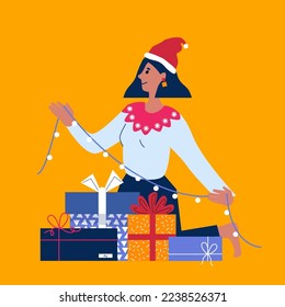 Beauty woman wearing christmas hat and sweater. Holding garland in hand, looking happy surprised with smile. Merry Christmas. Happy New Year. Gifts boxes bows. Winter Holidays. Xmas greetings.