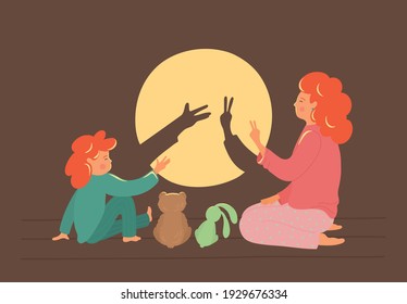 Bedtime story. Cute shadow theatre. Mother with child play in the shadows theatre. Children development concept.
