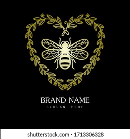 Bee logo. Gold bee with heart-shaped bouquets and black background