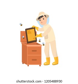 Beekeeper collects honey from bees. Beekeeper in a bee protection suit with a jar of honey.