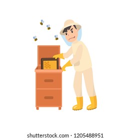 Beekeeper collects honey from bees. Beekeeper in a bee protection suit with a jar of honey.
