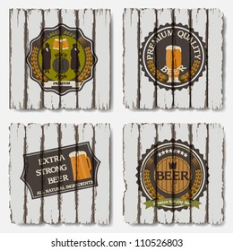 Beer badges and labels on old wood background