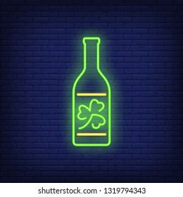 Beer bottle with clover on label neon sign. Saint Patricks Day and bar design. Night bright neon sign, colorful billboard, light banner. Vector illustration in neon style.
