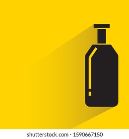 beer bottle with drop shadow in yellow background